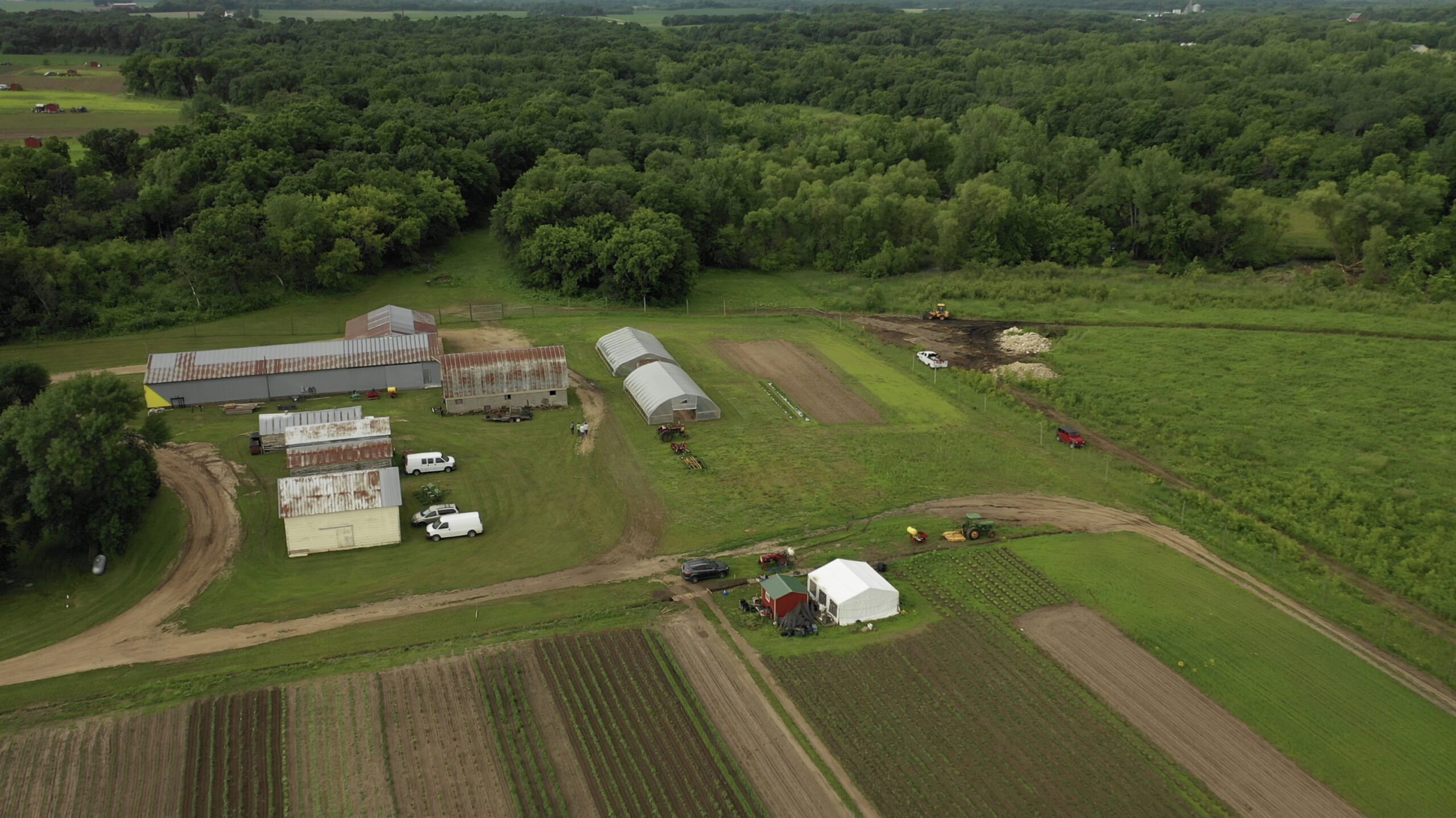 An aerial view of a Minnesota farmstead including fields and farm buildings