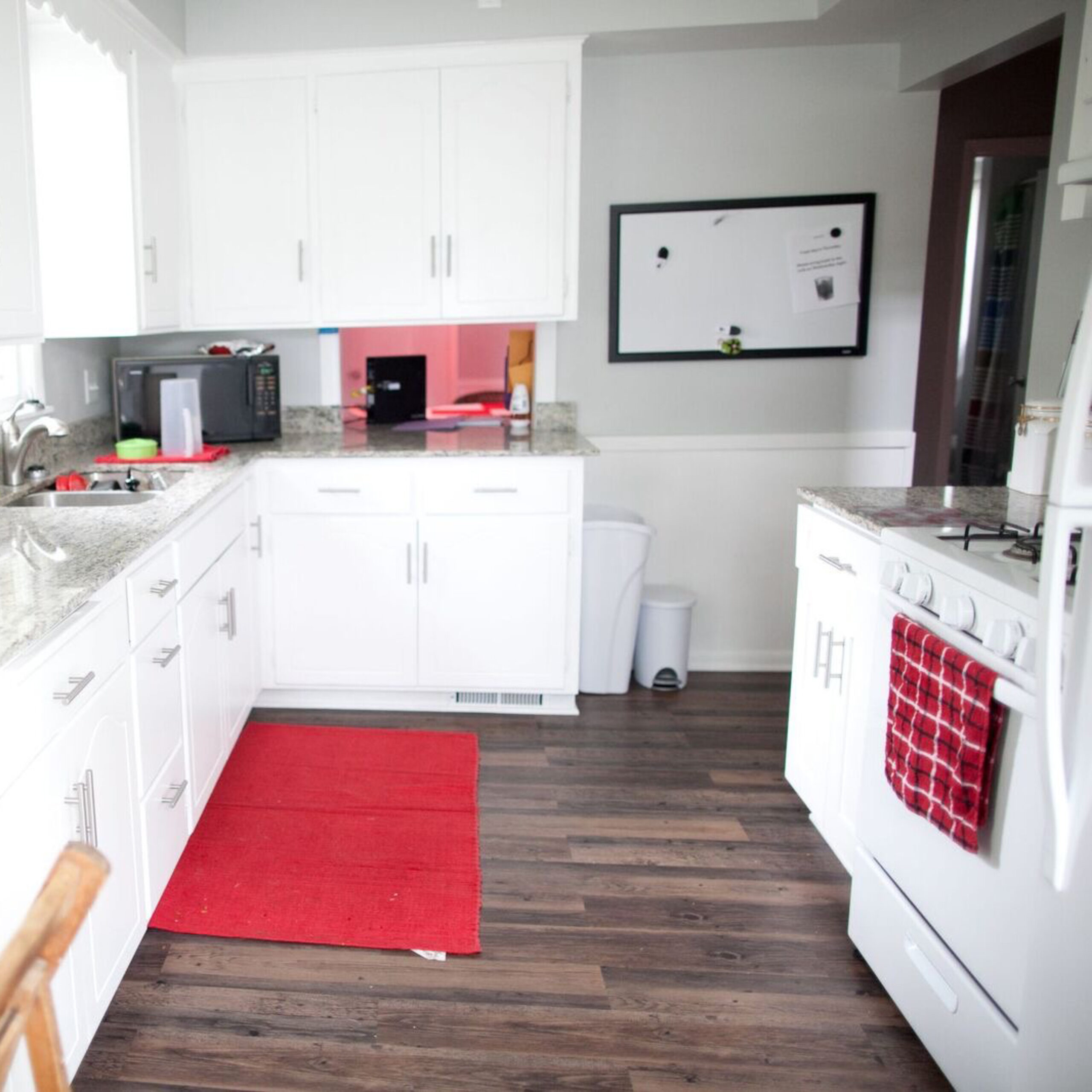 Apartment kitchen with white counters and appliances